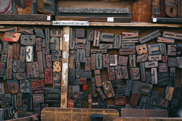 Scattered letters & numbers from a printing press in a tray.