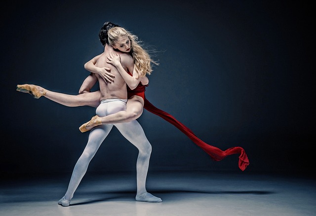 Ballet dancers pose in a contrast of strength and grace.