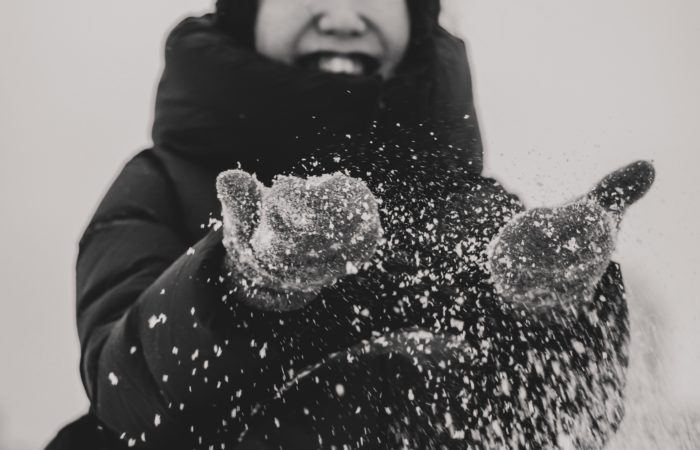 person laughing in snow