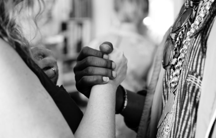 A white woman and African American man holding hands
