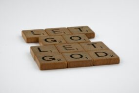 Scrabble tiles spelling out "Let Go Let God"