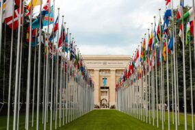 The United Nations building in Geneva with flags of many nations out front