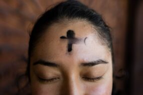 A woman with a cross on her forehead