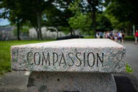 A stone bench at West Point with the word COMPASSION on the side